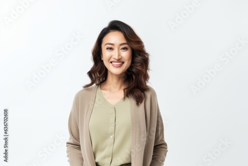 Portrait of a smiling young asian businesswoman standing over white background © Anne-Marie Albrecht