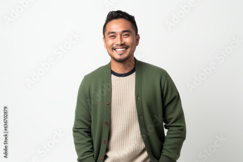 Obraz na płótnie Lifestyle portrait of a Indonesian man in his 30s in a white background wearing a chic cardigan w salonie