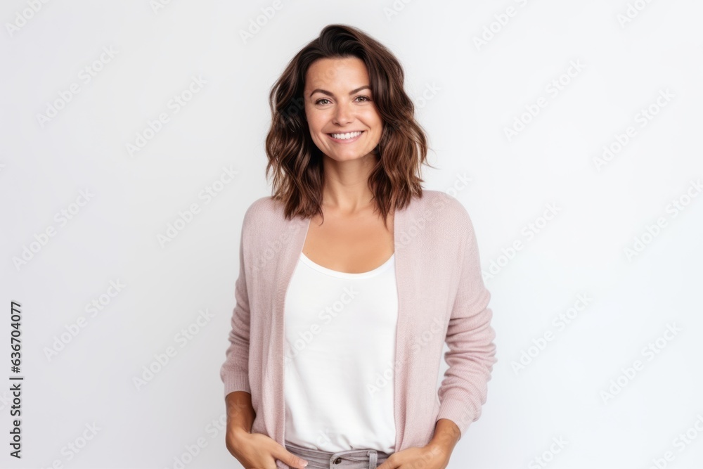 Portrait of a smiling woman standing with hands in pockets over white background Portrait of a smiling woman standing with hands in pockets over white background
