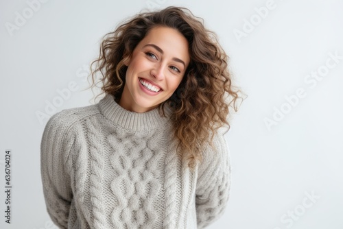 Lifestyle portrait of a Russian woman in her 30s in a white background wearing a cozy sweater © Anne-Marie Albrecht