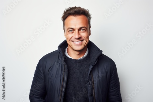 Medium shot portrait of a Russian man in his 40s in a white background wearing a chic cardigan