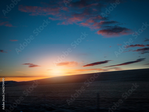 Photo of a beautiful sunset over a serene Icelandic body of water
