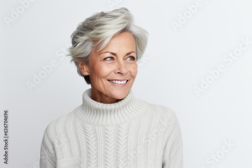 Group portrait of a Russian woman in her 50s in a white background wearing a cozy sweater