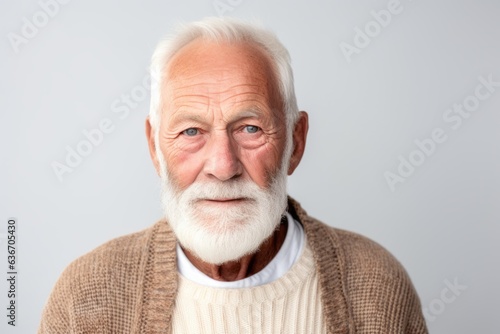 Group portrait of a Russian man in his 80s in a white background wearing a chic cardigan