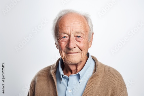Group portrait of a Russian man in his 80s in a white background wearing a chic cardigan