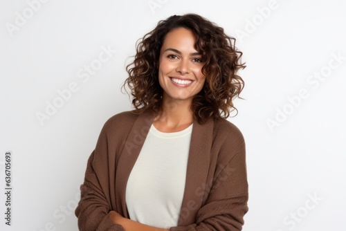 Group portrait of a Brazilian woman in her 30s in a white background wearing a chic cardigan