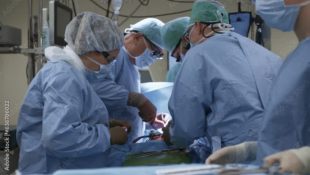 Team of doctors perform surgery in operating room using sterile instruments. Process of treating patient with invasive method. Healthcare in modern clinic Team of doctors perform surgery in operating room using sterile instruments. Process of treating patient with invasive method. Healthcare in modern clinic
