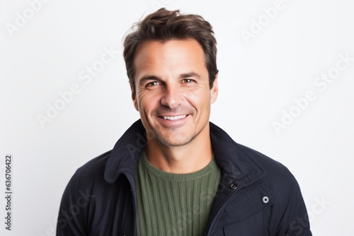 Group portrait of a Brazilian man in his 40s in a white background wearing a chic cardigan