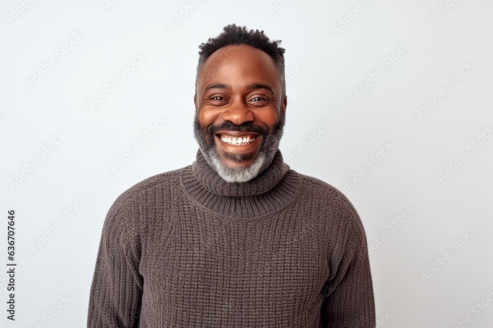 Medium shot portrait of a Nigerian man in his 40s in a white background wearing a cozy sweater Medium shot portrait of a Nigerian man in his 40s in a white background wearing a cozy sweater