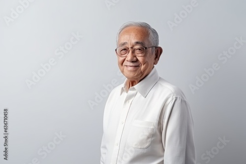 senior asian man in white shirt and eyeglasses on white background