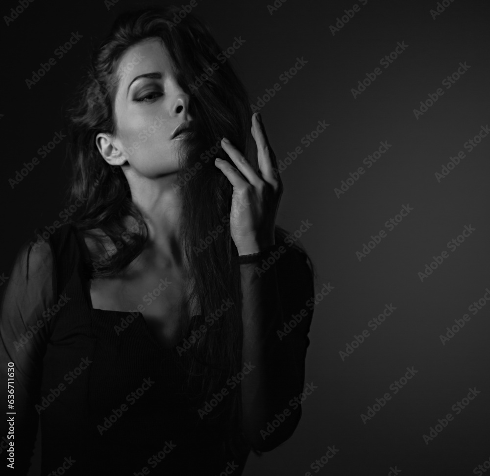 Beautiful makeup sexy woman touching and holding the fingers the long brown hair in style dress on black shadow background with empty copy space. Closeup profile . Black and white Beautiful makeup sexy woman touching and holding the fingers the long brown hair in style dress on black shadow background with empty copy space. Closeup profile . Black and white