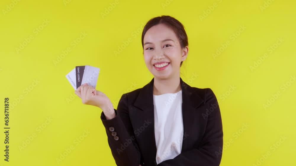 Portrait beautiful young asian business woman hold credit card or debit card for shopping payment and transaction with financial on yellow background, businesswoman showing atm, finance concept. Portrait beautiful young asian business woman hold credit card or debit card for shopping payment and transaction with financial on yellow background, businesswoman showing atm, finance concept.