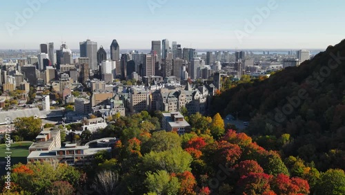 Aerial view of road in old district in Montreal. Drone footage of city, Montreal, Canada at autumn. Downtown cityscapes. View of Mont Royal mountain park.  Drone footage on sunset.
