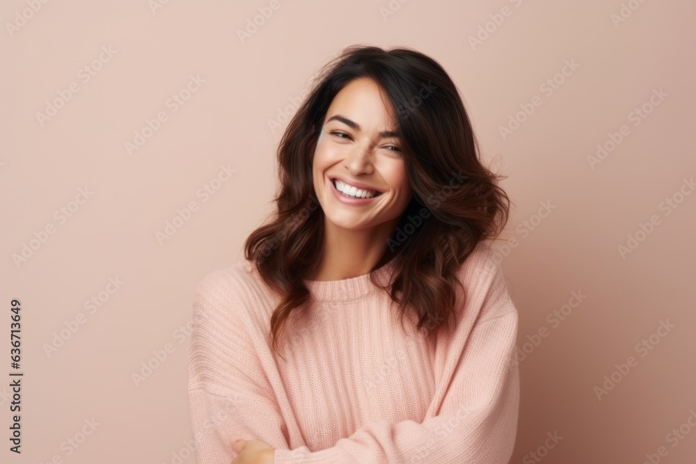 Portrait of a smiling young woman looking at camera isolated over beige background Portrait of a smiling young woman looking at camera isolated over beige background
