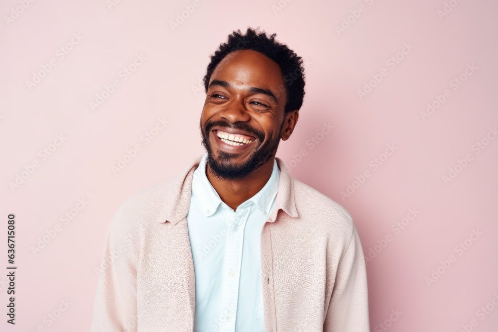 Medium shot portrait of a Nigerian man in his 30s in a pastel or soft colors background wearing a chic cardigan Medium shot portrait of a Nigerian man in his 30s in a pastel or soft colors background wearing a chic cardigan