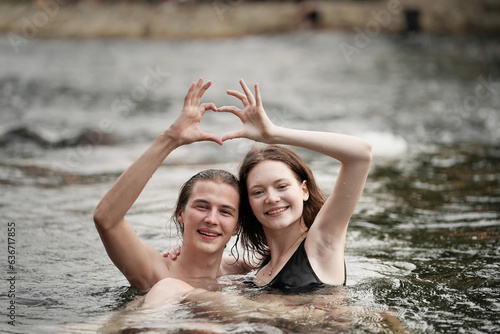 happy couple of lovers embracing in forest camp