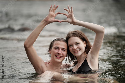 happy couple of lovers embracing in forest camp