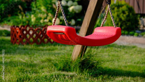 children's swing.Children's swing on the background of a lawn and flower beds in summer
