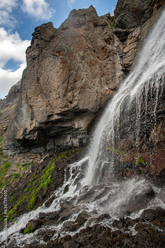 Beautiful photo with a mountain waterfall