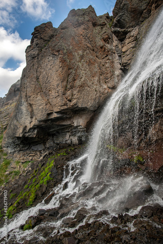 Beautiful photo with a mountain waterfall