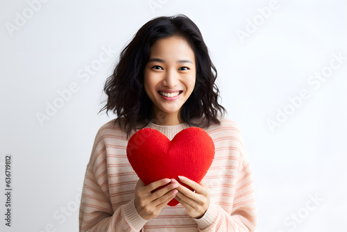 portrait of a woman holding a heart © AGSTRONAUT