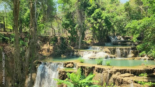 Beautiful limestone watarfall with clearly green-turquiose shade water is flowing down among the deep jungle which is located in Kanchanaburi province, Thailand. Nature environment 4k footage.	
 photo