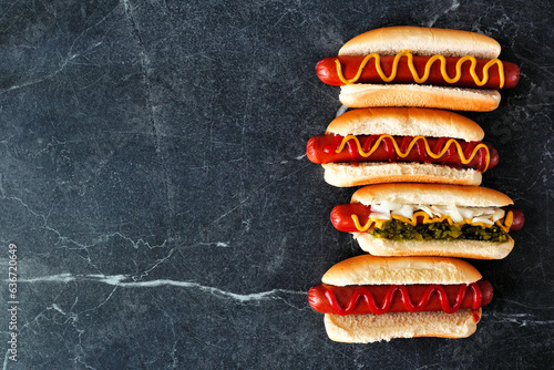Fényképezés Variety of hot dogs with an assortment of toppings