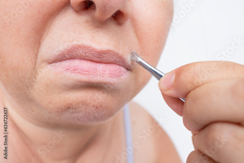 Tablou pe pânză removing facial hair around mouth, skill and precision required for using metal