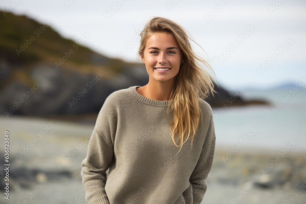 Group portrait of a Russian woman in her 20s in a beach background wearing a cozy sweater
