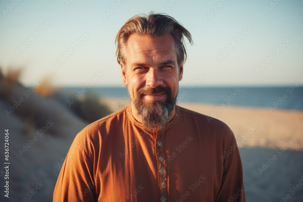 Medium shot portrait of a Russian man in his 40s in a beach background wearing a simple tunic Medium shot portrait of a Russian man in his 40s in a beach background wearing a simple tunic