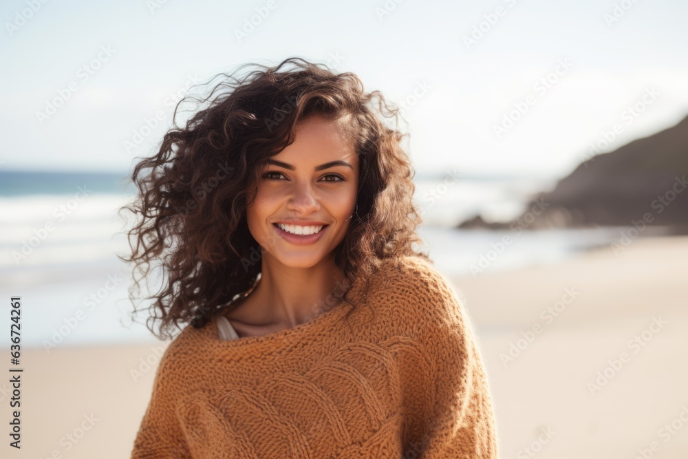 Medium shot portrait of a Brazilian woman in her 20s in a beach background wearing a cozy sweater Medium shot portrait of a Brazilian woman in her 20s in a beach background wearing a cozy sweater