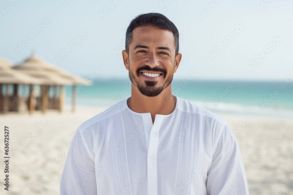 Portrait of handsome man smiling at camera on beach during summer vacation Portrait of handsome man smiling at camera on beach during summer vacation