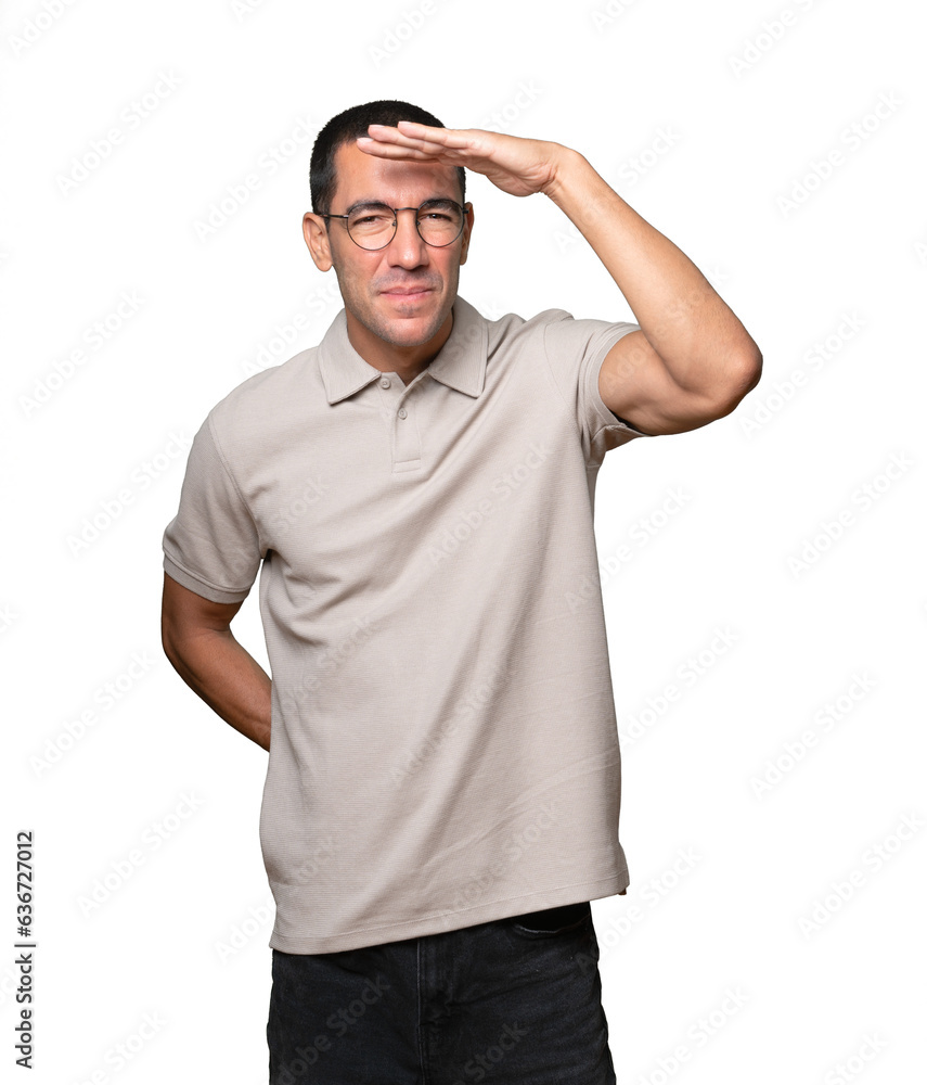 Astonished young man with a gesture of looking far Astonished young man with a gesture of looking far