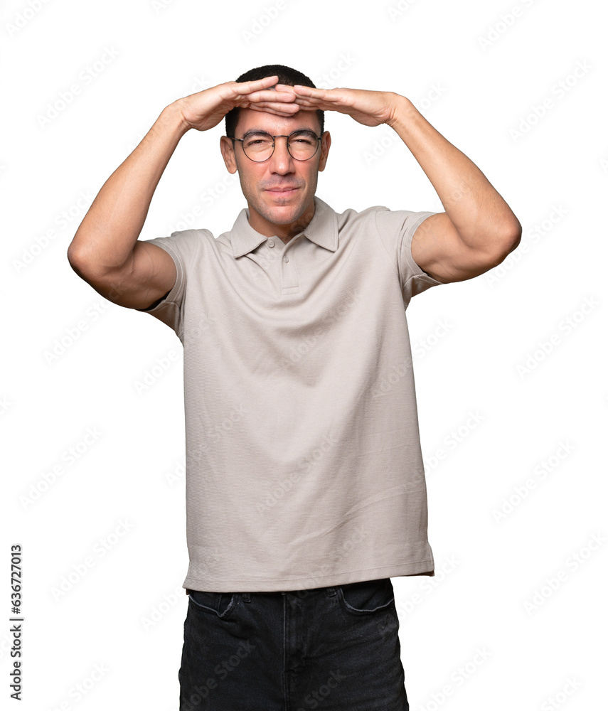 Astonished young man with a gesture of looking far Astonished young man with a gesture of looking far