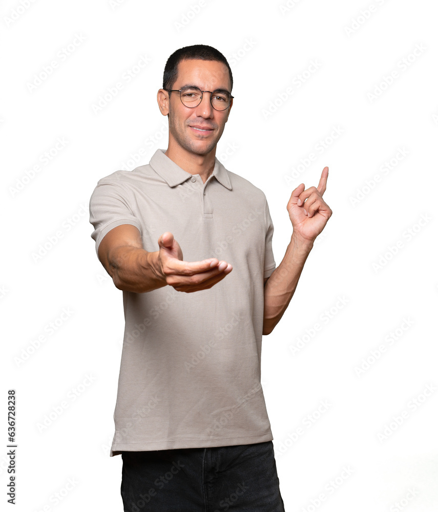 Happy young man doing a gesture of welcome with his hand Happy young man doing a gesture of welcome with his hand