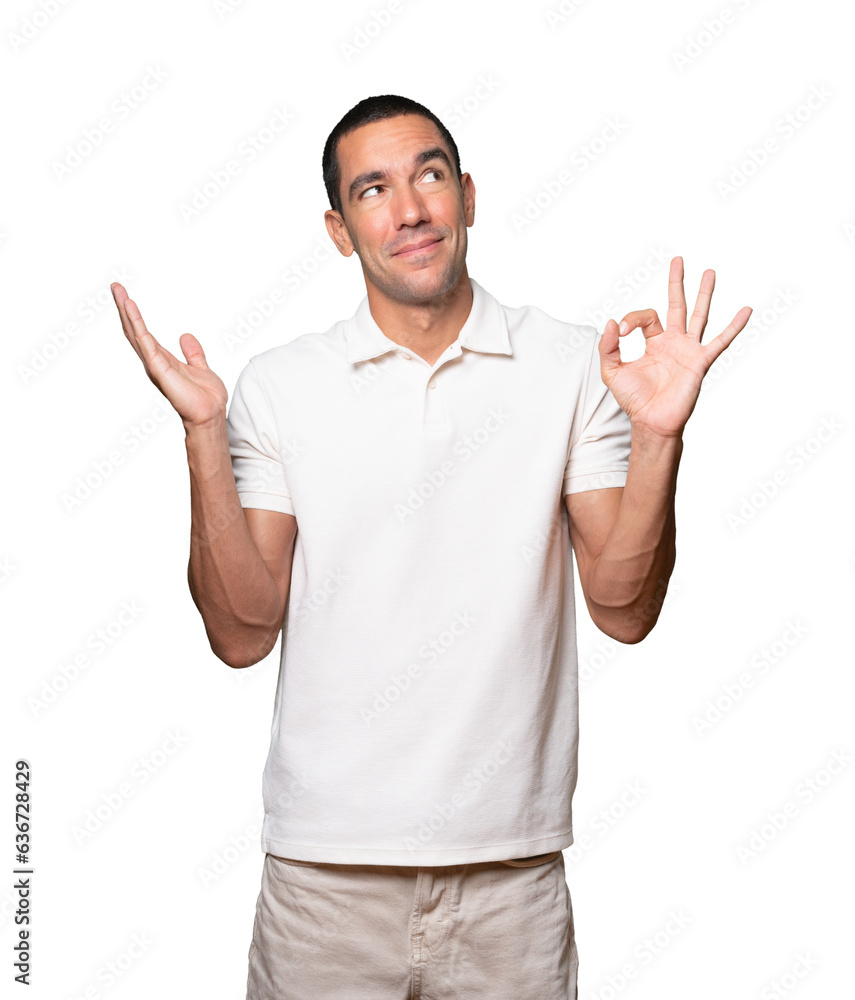 Worried young man doubting and making a gesture of approval Worried young man doubting and making a gesture of approval