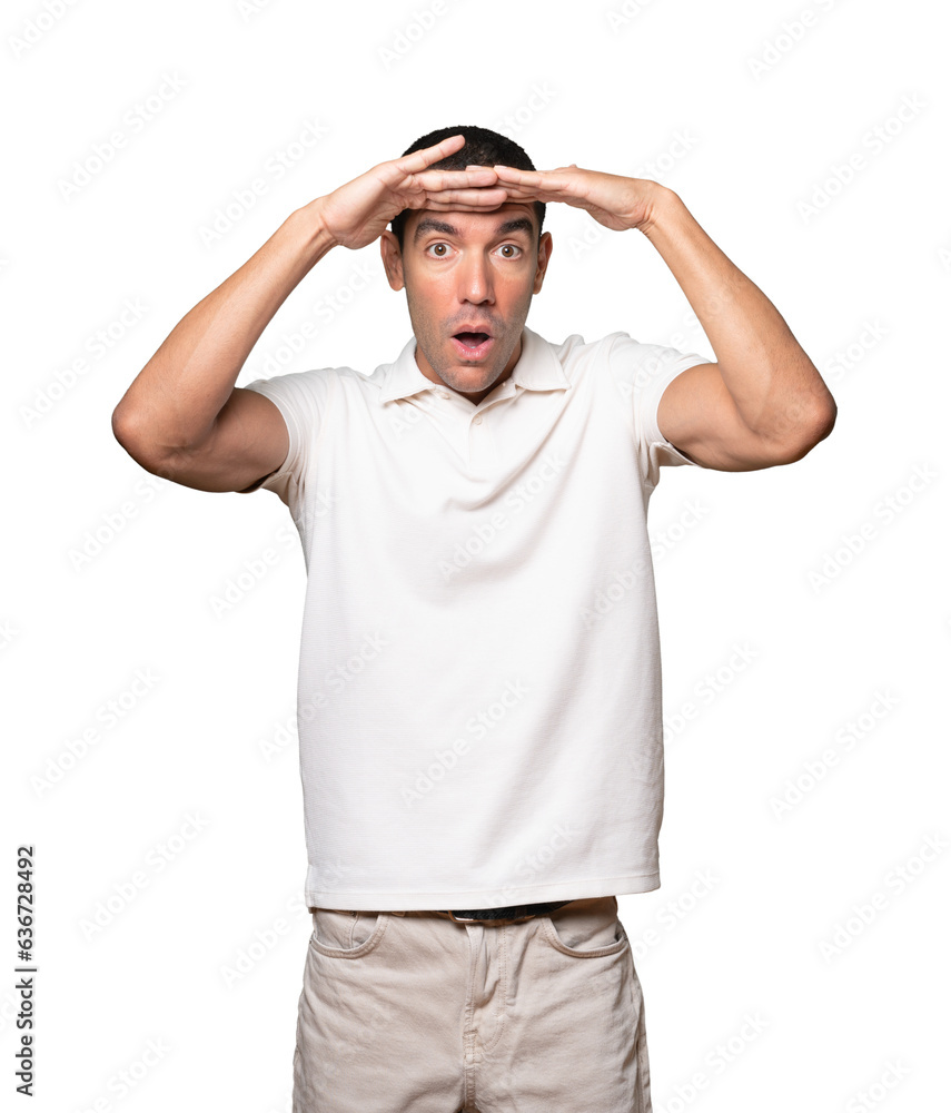 Concentrated young man with a gesture of looking far Concentrated young man with a gesture of looking far