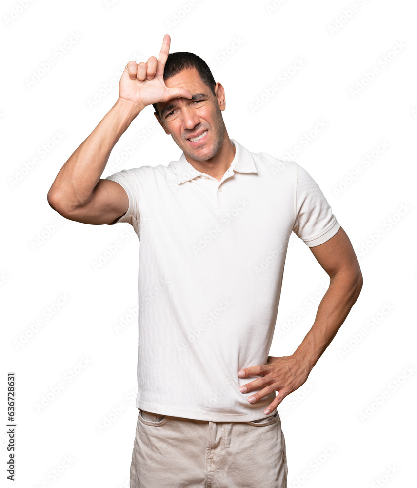 Serious young man doing a gesture of defeated Serious young man doing a gesture of defeated