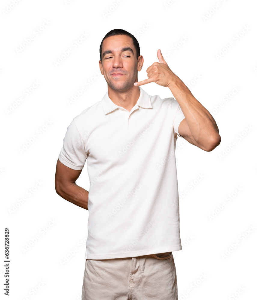 Hesitant young man making a gesture of calling with the hand Hesitant young man making a gesture of calling with the hand