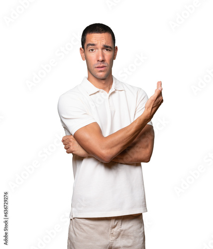 Puzzled young man doing a gesture of not understand