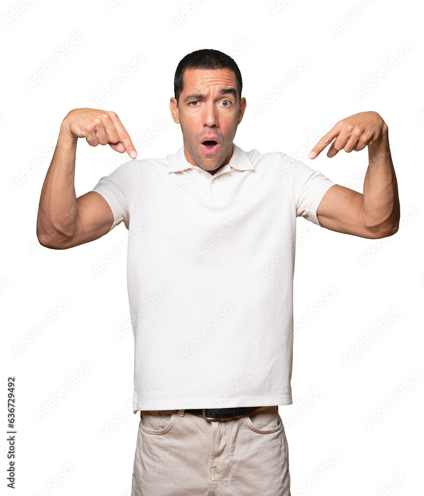 Fototapeta premium Surprised young man pointing down