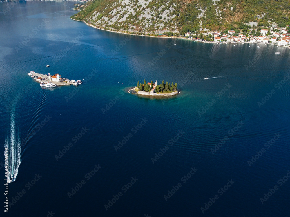 Naklejka premium Aerial view of Our Lady of the Rocks or Gospa od Skrpjela and Catholic monastery Saint George in the bay of Kotor, in city of Perast, Adriatic sea, Montenegro. Tourism destination.
