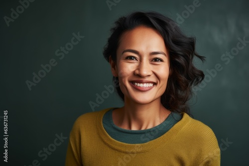 Portrait of a smiling asian woman standing in front of a chalkboard