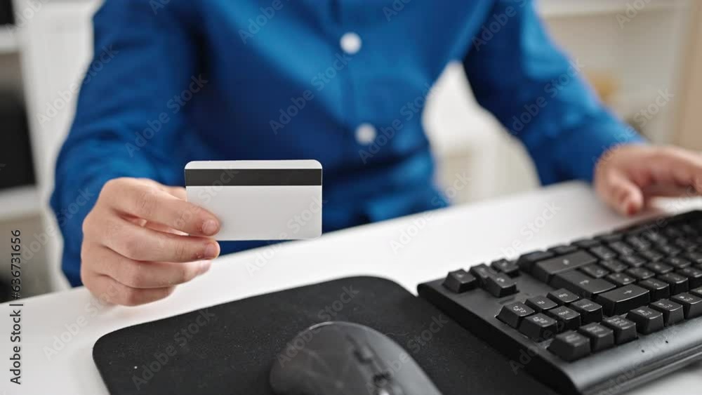 Young hispanic man business worker using computer and credit card at the office Young hispanic man business worker using computer and credit card at the office