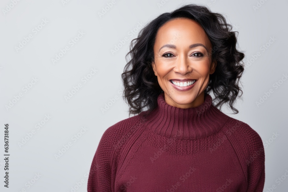 Portrait of a Chinese woman in her 40s in a white background wearing a cozy sweater Portrait of a Chinese woman in her 40s in a white background wearing a cozy sweater