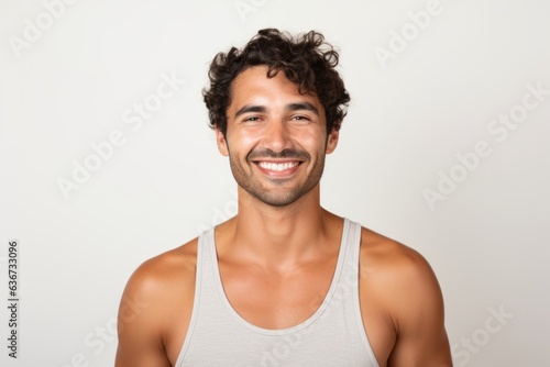 Portrait of a Brazilian man in his 30s in a white background wearing a sporty tank top photo