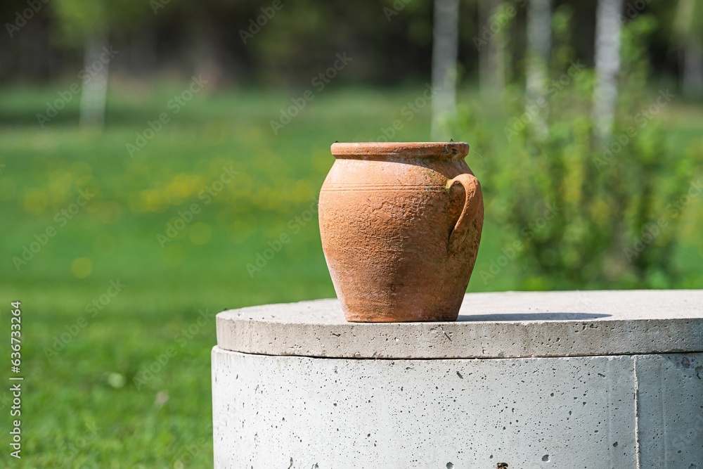 Ceramic vase with a rounded body outdoors on a sunny day Ceramic vase with a rounded body outdoors on a sunny day