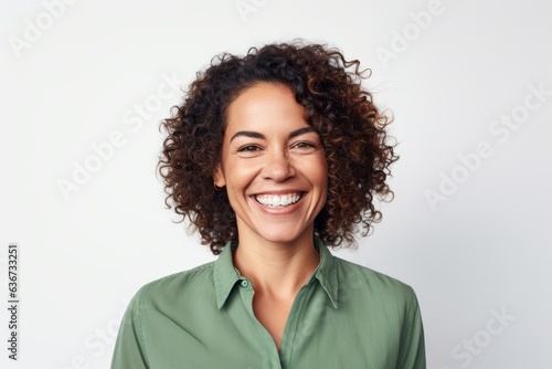 Portrait of a Brazilian woman in her 40s in a white background wearing a chic cardigan