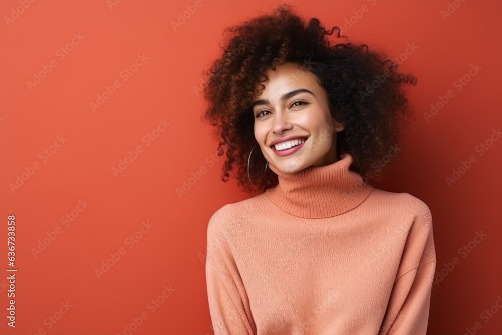 Portrait of a smiling african american woman in sweater on red background Portrait of a smiling african american woman in sweater on red background