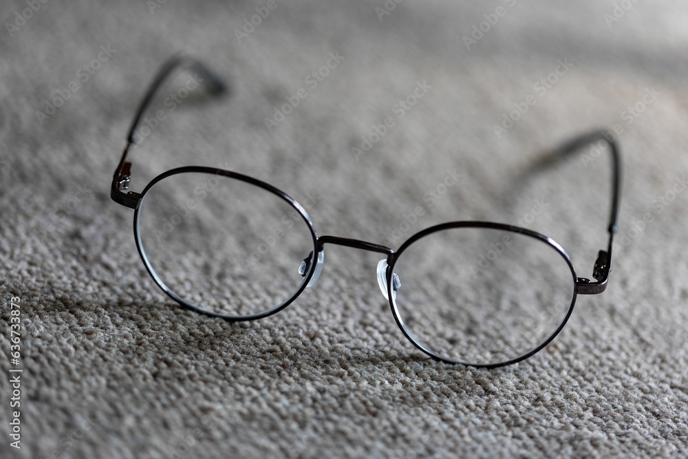 Close-up shot of a pair of eyeglasses on a flat surface